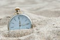 Pocket watch buried in sand. Royalty Free Stock Photo