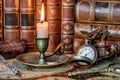 Pocket watch, burning candle and old books Royalty Free Stock Photo