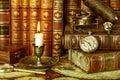 Pocket watch, burning candle and old books Royalty Free Stock Photo