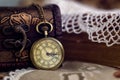 Pocket watch and casket on lace servet Royalty Free Stock Photo
