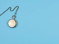 Pocket watch on a chain on a blue background