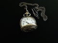 Pocket watch with chain in dark background Royalty Free Stock Photo