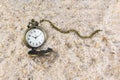 Pocket watch with chain in the sand. Time passing symbol Royalty Free Stock Photo