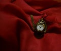 Pocket-watch on a crimson scarf