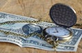 Pocket watch with dollars on wooden trunk Royalty Free Stock Photo