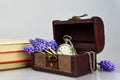 Pocket watch, flowers, books and treasure chest