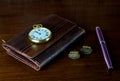 Leather Wallet with Pocket Watch Cuff Links and Fountain Pen on a Wooden Table Top