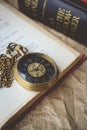 Pocket Watch with Old Books on Crumpled Paper in Vintage Tone Royalty Free Stock Photo