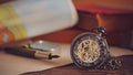 Pocket watch with old books on table. Royalty Free Stock Photo