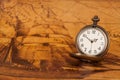 Pocket watch on old map background, vintage style Royalty Free Stock Photo