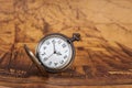 Pocket watch on old map background, vintage style Royalty Free Stock Photo