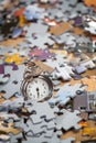 Pocket watch on a pile of jigsaw puzzle pieces Royalty Free Stock Photo