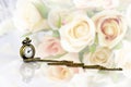 Pocket watch with rose bouquet on pastel tone background