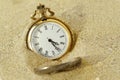 Pocket watch in the sand - Concept of time passing Royalty Free Stock Photo