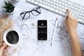 Podcast audio content concept. podcast application on mobile smartphone screen on workspace desk with coffee cup, earphones