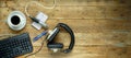 Podcast or audiobook concept, flat lay with headphones, vintage microphone, coffee and keyboard on wooden table