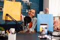 Podcast from social media vlogger with big bags gifts in home studio using professional microphone Royalty Free Stock Photo