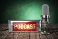 Podcast. Vintage microphone and signboard with text podcast