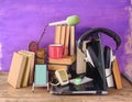Podcasting concept, books,vintage headphones, recording microphones, laptop and smartphone