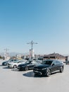 Podgorica, Montenegro - 14 august 2023: Various cars stand in an open parking lot near the houses