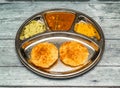 podi idli with curry thali served in dish isolated on wooden table top view of indian spicy food