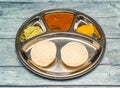 podi idli thali with curry served in dish isolated on wooden table top view of indian spicy food