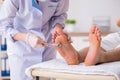 The podiatrist treating feet during procedure Royalty Free Stock Photo