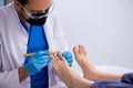 Podiatrist treating feet during procedure Royalty Free Stock Photo