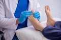 Podiatrist treating feet during procedure