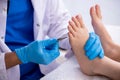 Podiatrist treating feet during procedure Royalty Free Stock Photo