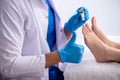 Podiatrist treating feet during procedure Royalty Free Stock Photo