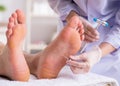 Podiatrist treating feet during procedure Royalty Free Stock Photo