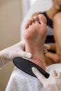 Beautician foot treatment.Treatment of feet and nails. Royalty Free Stock Photo