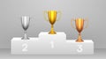 Podium with golden, silver and bronze cups Royalty Free Stock Photo