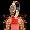 Podium with golden wrist watch. 3D rendering