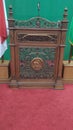 A podium made of teak wood with a red carpet as a base and a green background