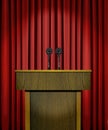 Podium and microphones over red curtains