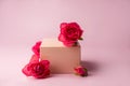 Podium for product photo background with roses. geometric objects and flowers.