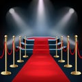 Podium with red carpet and barrier rope in glow of spotlights