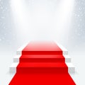 Podium with a red carpet in the illumination of the beams of searchlights.