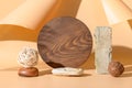 Podiums for products of natural materials stone, bricks, wooden board with sunny shadow on beige background. Creative template or