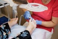 Podology treatment. Podiatrist treating toenail fungus. Doctor removes calluses, corns and treats ingrown nail. Hardware Royalty Free Stock Photo