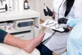 Podology treatment. Podiatrist treats foot. Podiatry doctor or dermatologist treats the patient in modern clinic