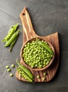 Pods green peas on wooden backgrounds