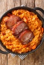 Podvarak Serbian Baked Sauerkraut with smoked meat closeup in the pan. Vertical top view Royalty Free Stock Photo