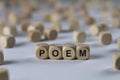 Poem - cube with letters, sign with wooden cubes