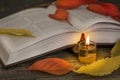 Poetry open book with candle Royalty Free Stock Photo