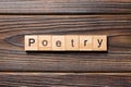 Poetry word written on wood block. Poetry text on wooden table for your desing, Top view concept Royalty Free Stock Photo