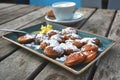 `Poffertjes`, a traditional Dutch batter treat dish resembling small, fluffy pancakes, served with powdered sugar