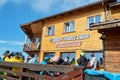 Skiers and tourists having a break at Julius Romer Hutte / Postavaru hut on a sunny Winter day